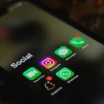 A close-up shot of smartphone displaying social media apps icons on screen.