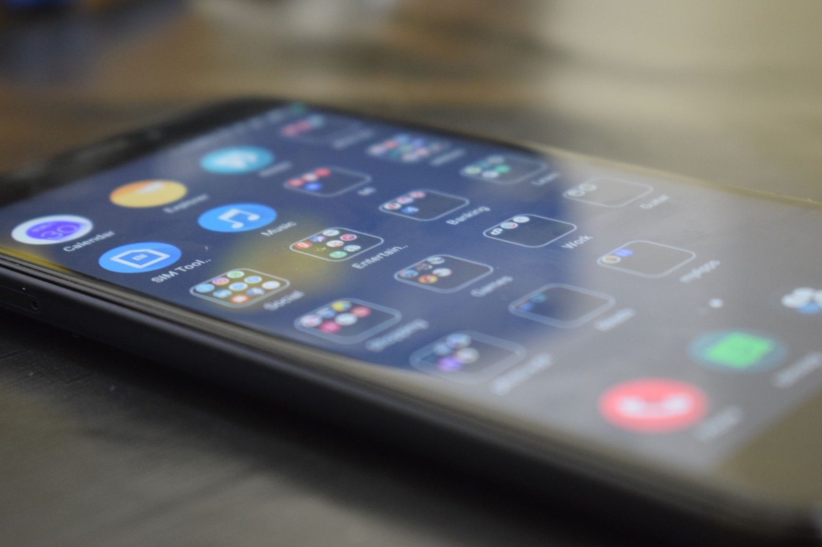 Close-up shot of a smartphone screen showing various app icons, indicating digital technology use.