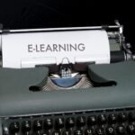 Close-up of a vintage typewriter displaying the concept of e-learning on paper.