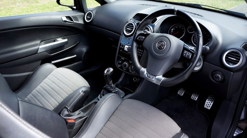 Close-up view of a modern car interior featuring a steering wheel and dashboard.