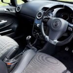 Close-up view of a modern car interior featuring a steering wheel and dashboard.