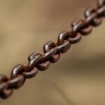 Detailed macro shot of a rusty metal chain outdoors in Minas Gerais, Brazil.