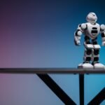 Close-up of a futuristic robot toy on a table with a gradient blue-pink background.