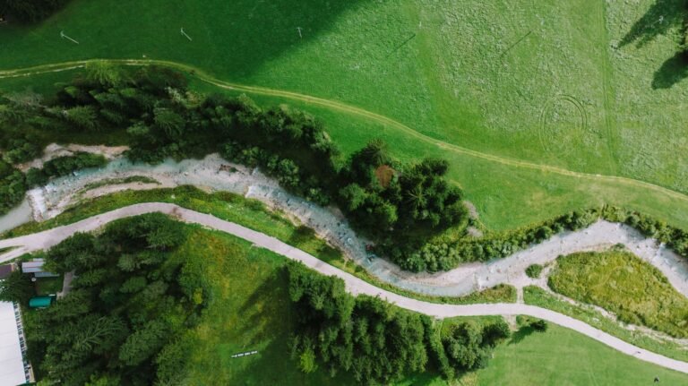 A breathtaking aerial view of lush greenery and winding paths in Canazei, Italy.